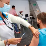 Un hombre recibe la vacuna contra la covid en el punto de vacunación masivo instalado en el Wizink Center de Madrid