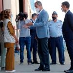 El rey Felipe VI y el presidente del Gobierno, Pedro Sánchez, conversan con varias personas durante su visita al centro de acogida temporal instalado en la base de Torrejón de Ardoz