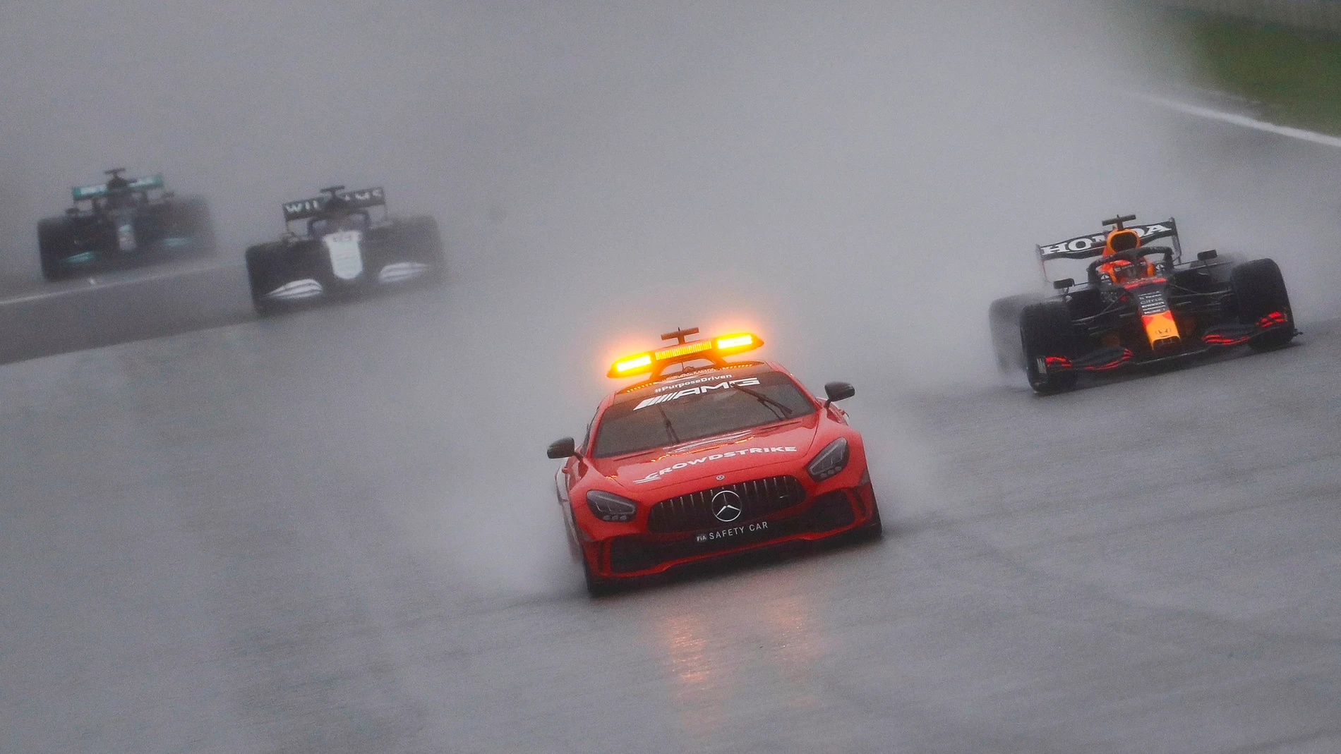 El coche de seguridad lidera a los coches de F-1 en el circuito de Spa-Francorchamps