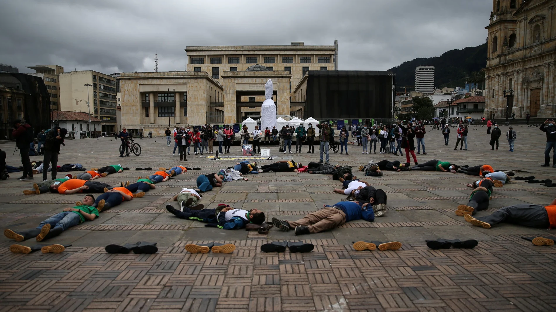 People participate in a symbolic protest to commemorate the more than 6,400 people who were reportedly killed by the army in 'false positive' cases during the war against FARC rebels, in Bogota, Colombia August 30, 2021. REUTERS/Luisa Gonzalez