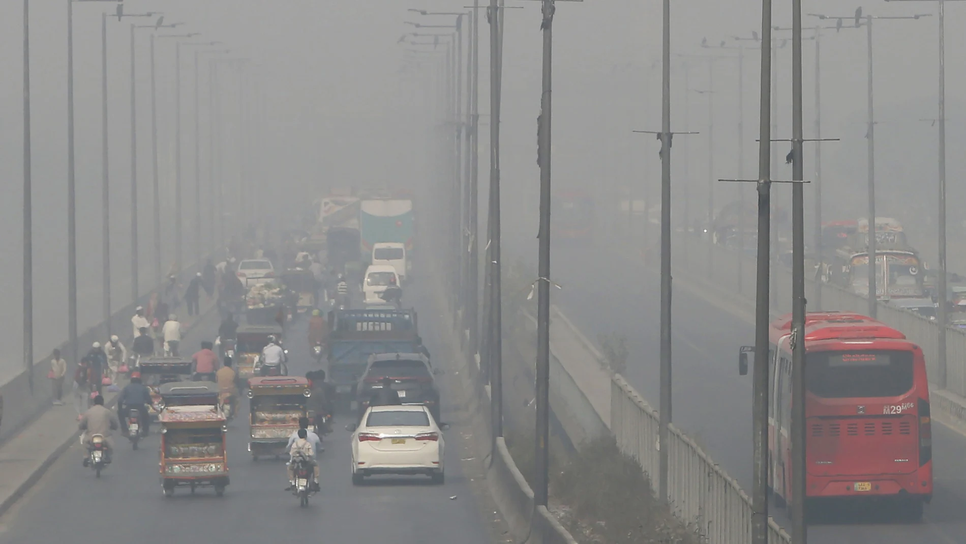 FILE - In this Wednesday, Nov. 11, 2020 file photo, vehicles drive on a highway as smog envelops the area of Lahore, Pakistan. The World Health Organization said Wednesday Sept. 22, 2021, the negative health impacts of poor air quality kick in at lower levels than it previously thought, announcing revisions to its guidelines on air quality that set a higher bar for policymakers in a world where 90 percent of people already live in areas with one particularly harmful type of pollutant. (AP Photo/K.M. Chaudary, File)