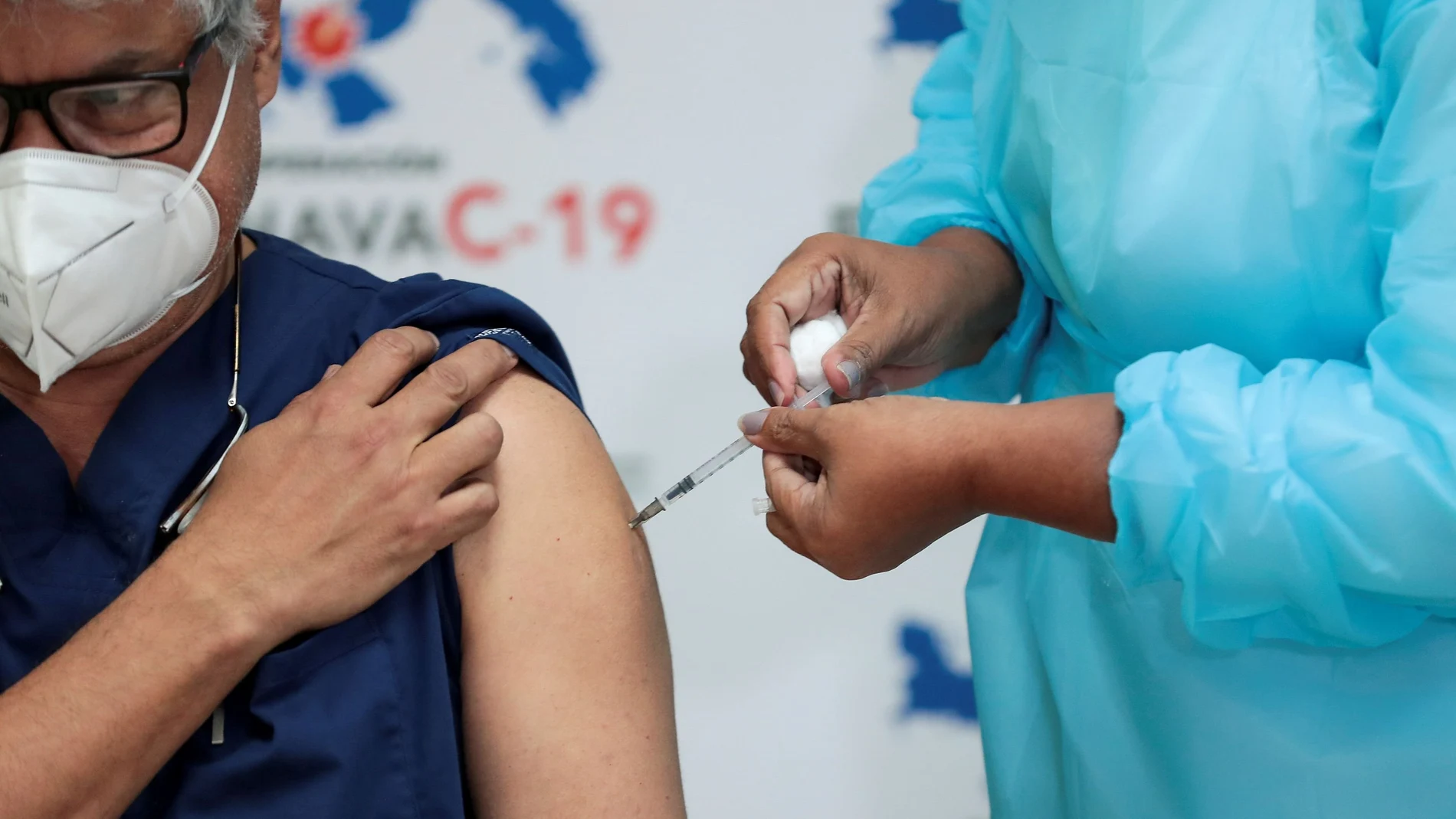 FILE PHOTO: A Panamanian health worker receives the second shot of the Pfizer-BioNTech COVID-19 vaccine at the Santo Tomas Hospital, in Panama City, Panama February 17, 2021. REUTERS/Erick Marciscano/File Photo