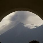 The "Volcan de Fuego," or Volcano of Fire, i seen through an archway as it blows outs a thick cloud of ash, seen from San Miguel Duenas, Guatemala, Thursday, Sept. 23, 2021. According to a bulletin published by the Guatemalan Vulcanology Institute, the volcano has spewed lava and ash in a series of explosions that have not yet forced any evacuations. (AP Photo/Moises Castillo)