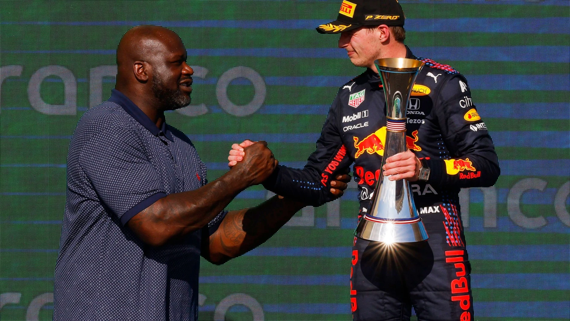 Formula One F1 - United States Grand Prix - Circuit of the Americas, Austin, Texas, U.S. - October 24, 2021 American former professional basketball player Shaquille O'Neal presents the winner trophy to Red Bull's Max Verstappen on the podium REUTERS/Brian Snyder