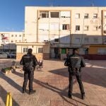 Agentes de la Policía Nacional, frente a la vivienda del número 231 de la calle Estanislao Rolandi de Cartagena, donde el sábado por la noche resultó muerto un hombre y otros dos resultaron heridos de bala, uno de ellos muy grave por un disparo en el cráneo, en un tiroteo entre traficantes de droga en la barriada Virgen de la Caridad, de Cartagena (Murcia)