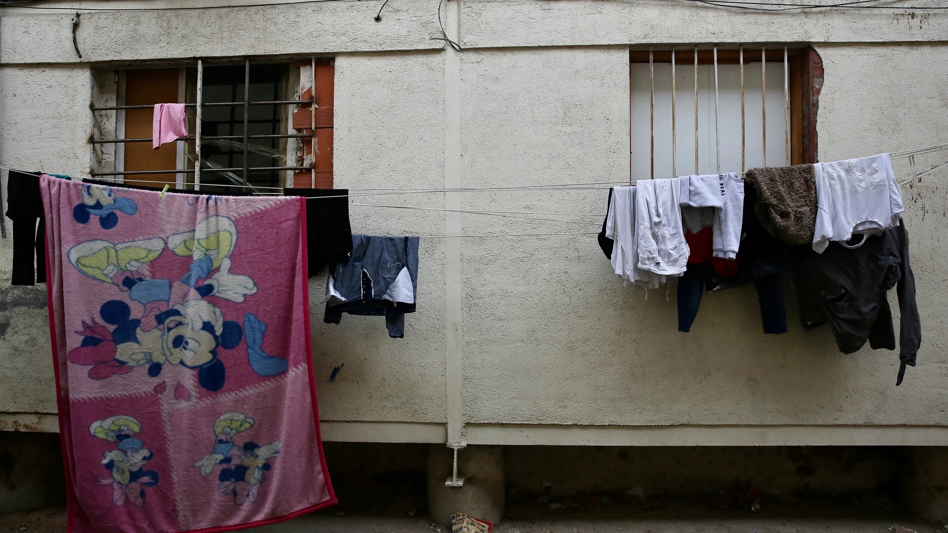 Los penúltimos vecinos de la colonia de la Uva en Hortaleza abandonan sus casas (que son tapiadas por operarios municipales) para ocupar nuevos pisos, donde el IVIMA los ha realojado.