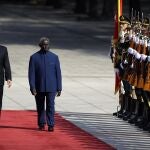 FILE - Chinese Premier Li Keqiang, left, and Solomon Islands Prime Minister Manasseh Sogavare review an honor guard during a welcome ceremony at the Great Hall of the People in Beijing, Wednesday, Oct. 9, 2019. The Solomon Islands' decision to switch its diplomatic allegiance from Taiwan to Beijing in 2019, has been blamed for arson and looting in the capital Honiara, where protesters are demanding the prime minister's resignation. (AP Photo/Mark Schiefelbein, File)