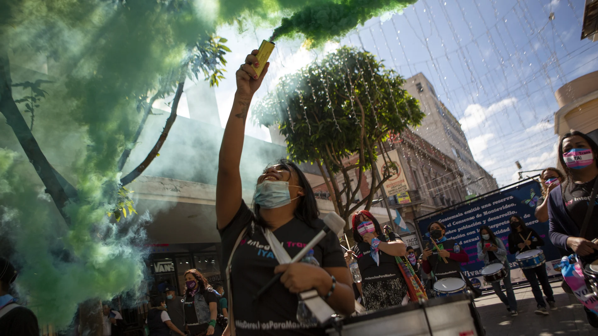 A woman waves a flare during a march marking the International Day for the Elimination of Violence Against Women, in Guatemala City, Thursday, Nov. 25, 2021. (AP Photo/Oliver de Ros)