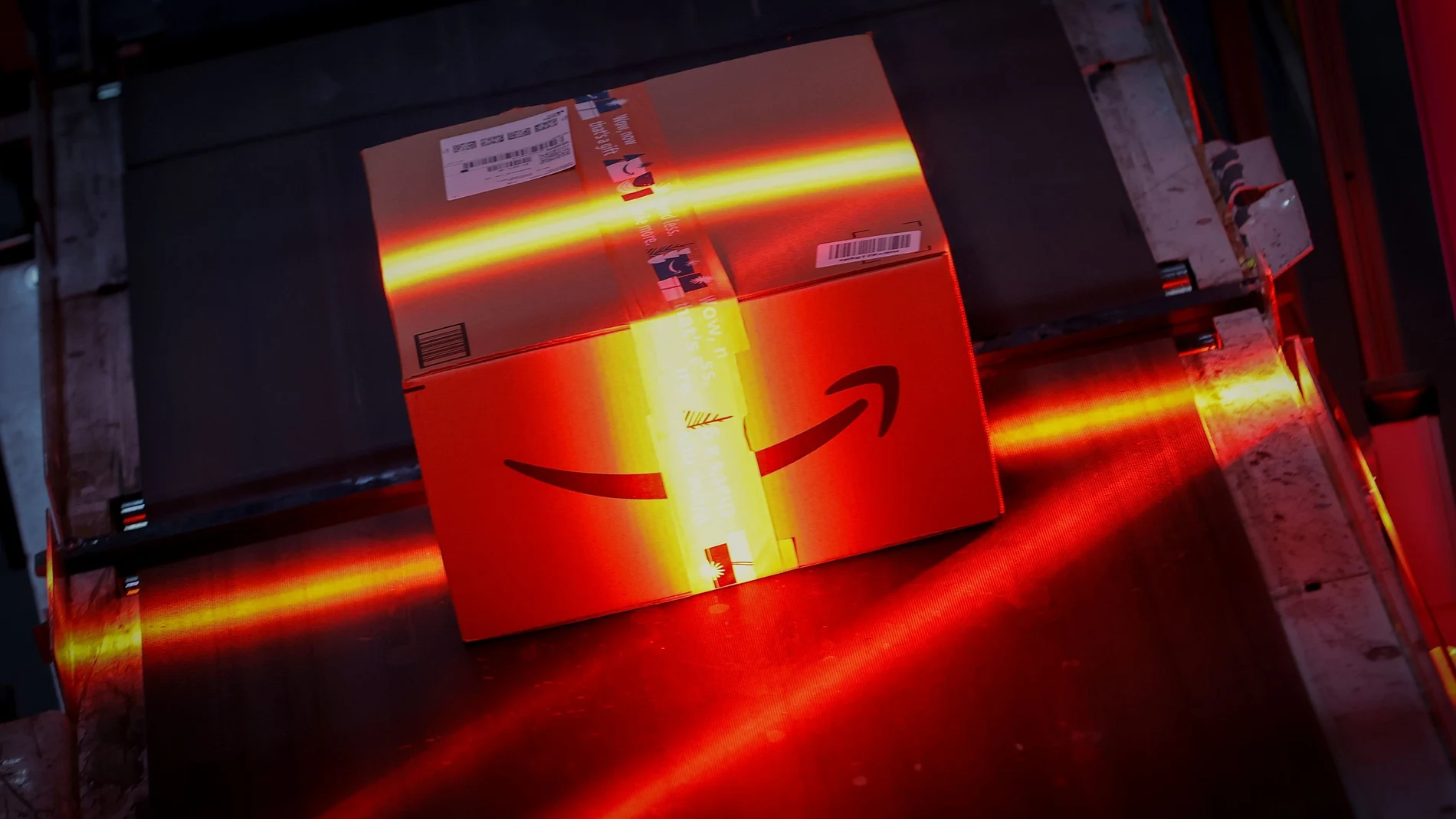 A fast-moving conveyor belt moves a package through a scanning machine on its way to a delivery truck during operations on Cyber Monday at Amazon's fulfillment center in Robbinsville, New Jersey, U.S., November 29, 2021. REUTERS/Mike Segar