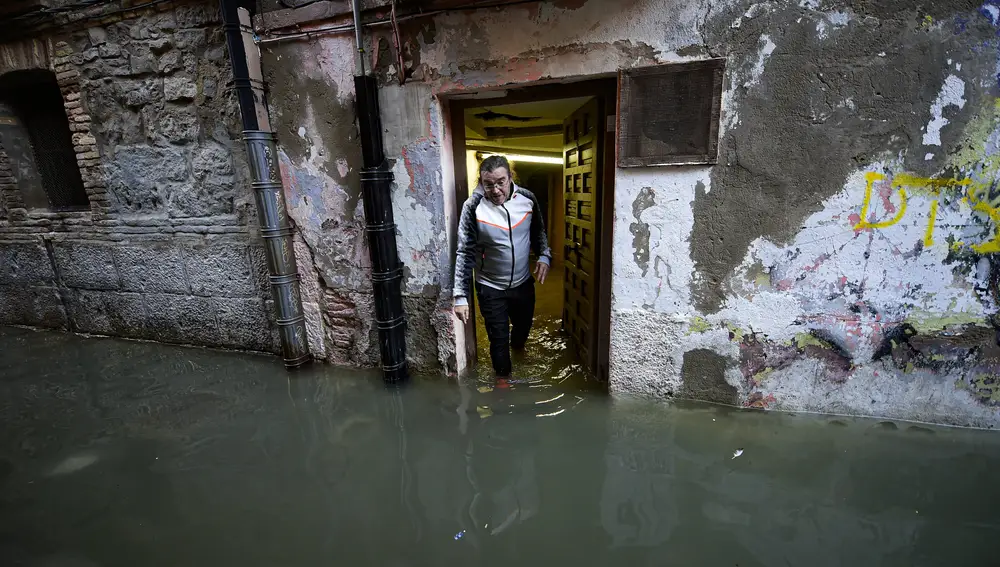 Ramon Rivas leaves his home in a flooded area near the Ebro River in Tudela, northern Spain, Sunday, Dec. 12, 2021. Heavy rain has led to flooding in northern Spain. (AP Photo/Alvaro Barrientos)