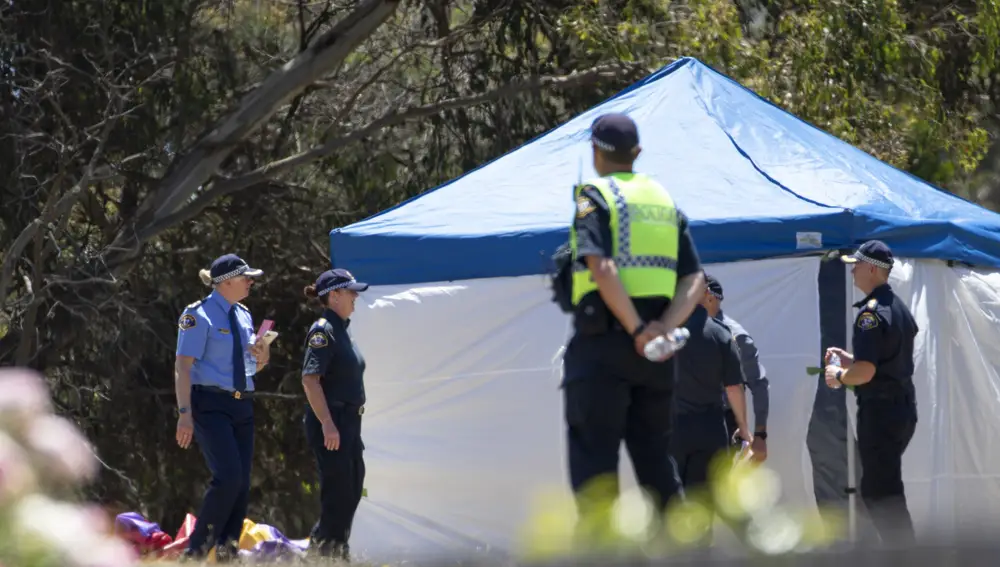 Emergency services personnel work the scene of a deadly incident involved with a jumping castle at the Hillcrest Primary School in Devonport, Tasmania, Thursday, Dec. 16, 2021. Multiple children have died and others are in critical condition after falling from a bouncy castle that was lifted 10 meters (33 feet) into the air by a gust of wind at a junior school on the island state of Tasmania on Thursday. (Grant Wells/AAP Image via AP)