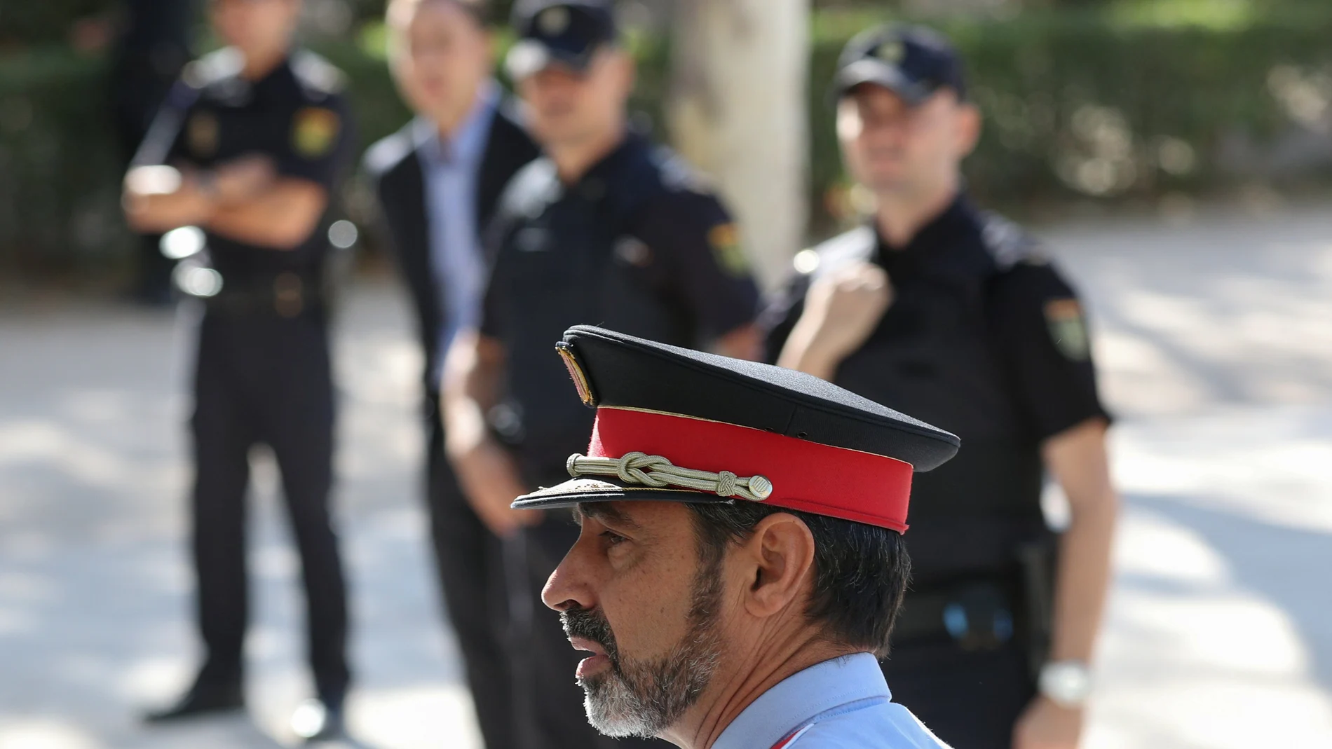 Josep Lluis Trapero, the head of Catalan police, walks past National Police officers as he leaves the Spain's High Court after testifying for the alleged crime of sedition in relation to arrests of high-ranking officials over the organisation of a banned independence vote in Madrid, Spain, October 6, 2017. REUTERS/Sergio Perez