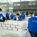 Voluntarios preparan las cinco mil cajas para la Gran Cena de Navidad que llegará a 20.000 personas vulnerables gracias a la iniciativa de Fundación La Caixa, CaixaBank y ONG CESAL