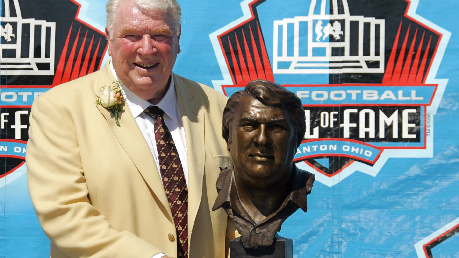 FILE - Broadcaster and former Oakland Raiders coach John Madden poses with his bust after enshrinement into the Pro Football Hall of Fame Saturday, Aug. 5, 2006, in Canton, Ohio. John Madden, the Hall of Fame coach turned broadcaster whose exuberant calls combined with simple explanations provided a weekly soundtrack to NFL games for three decades, died Tuesday, Dec. 28, 2021, the NFL said. He was 85.(AP Photo/Mark Duncan, File)