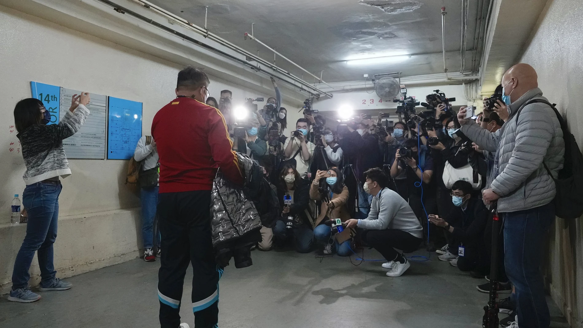 Senior editor of Stand News Ronson Chan, is surrounded by journalists outside his office after released from police station in Hong Kong, Wednesday, Dec. 29, 2021. Hong Kong police raided the office of the online news outlet on Wednesday after arresting several people for conspiracy to publish a seditious publication. (AP Photo/Vincent Yu)