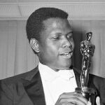 FILE - Actor Sidney Poitier poses with his Oscar for best actor for "Lillies of the Field" at the 36th Annual Academy Awards in Santa Monica, Calif. on April 13, 1964. Poitier, the groundbreaking actor and enduring inspiration who transformed how Black people were portrayed on screen, became the first Black actor to win an Academy Award for best lead performance and the first to be a top box-office draw, died Thursday, Jan. 6, 2022 in the Bahamas. He was 94. (AP Photo, File)