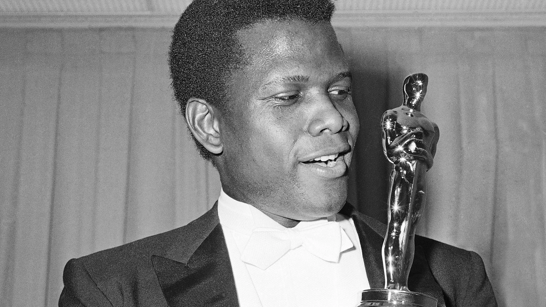 FILE - Actor Sidney Poitier poses with his Oscar for best actor for "Lillies of the Field" at the 36th Annual Academy Awards in Santa Monica, Calif. on April 13, 1964. Poitier, the groundbreaking actor and enduring inspiration who transformed how Black people were portrayed on screen, became the first Black actor to win an Academy Award for best lead performance and the first to be a top box-office draw, died Thursday, Jan. 6, 2022 in the Bahamas. He was 94. (AP Photo, File)