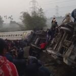 This image from video shows rescuers looking inside derailed coaches after a passenger train derailed in Jalpaiguri, West Bengal state, Thursday, Jan.13, 2022. At least three people died and more than 25 were injured. (K K Productions via AP)