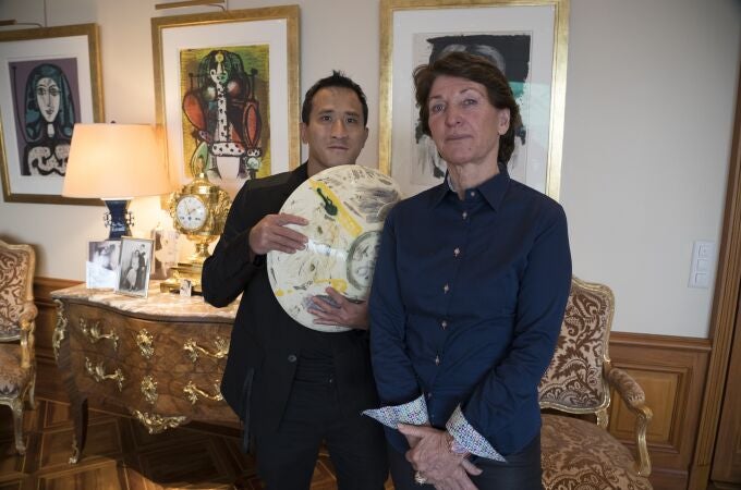 Marina Picasso, nieta del artista Pablo Picasso, y su hijo Florian Picasso posan con una obra de arte de cerámica de Pablo Picasso en Ginebra.