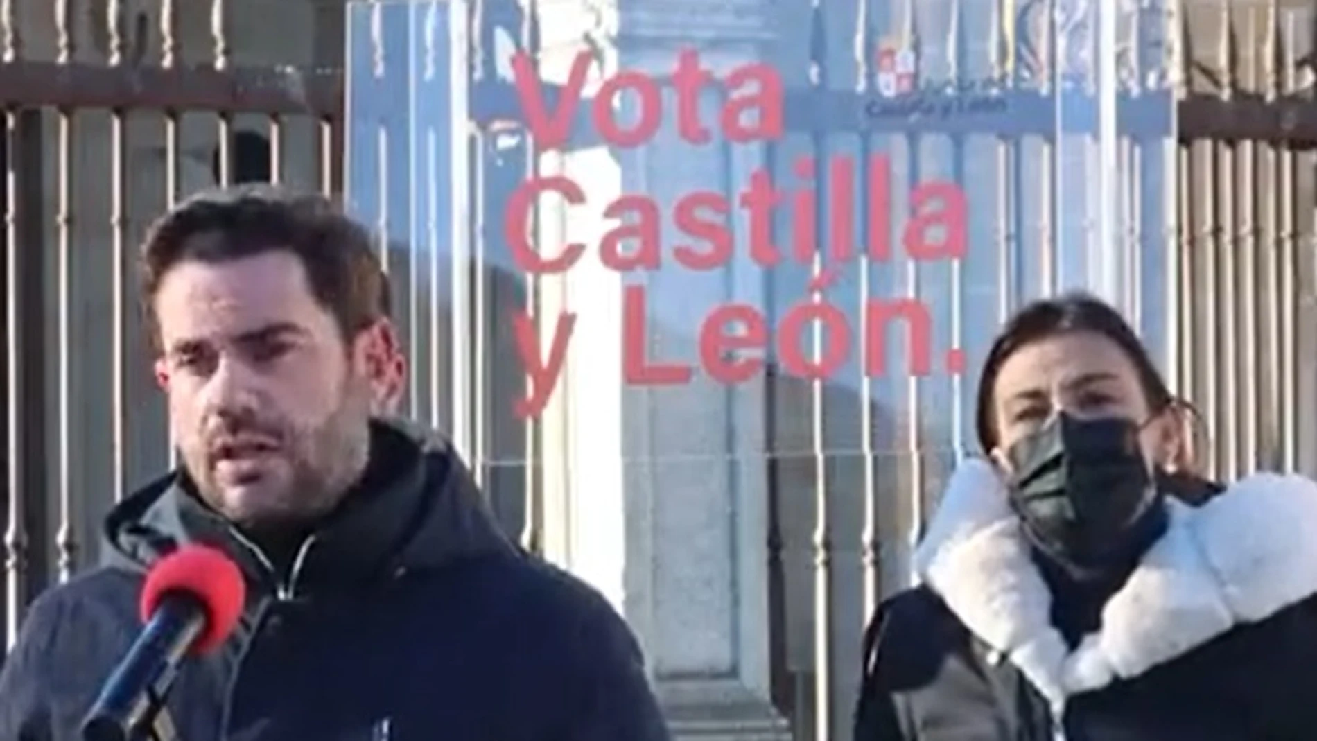 La candidata del PSOE por Zamora, Ana Sánchez, escucha a Antidio Fagúndez con el soporte equivocado al fondo, en el que se lee Vota Castilla y León junto al logotipo de la Junta