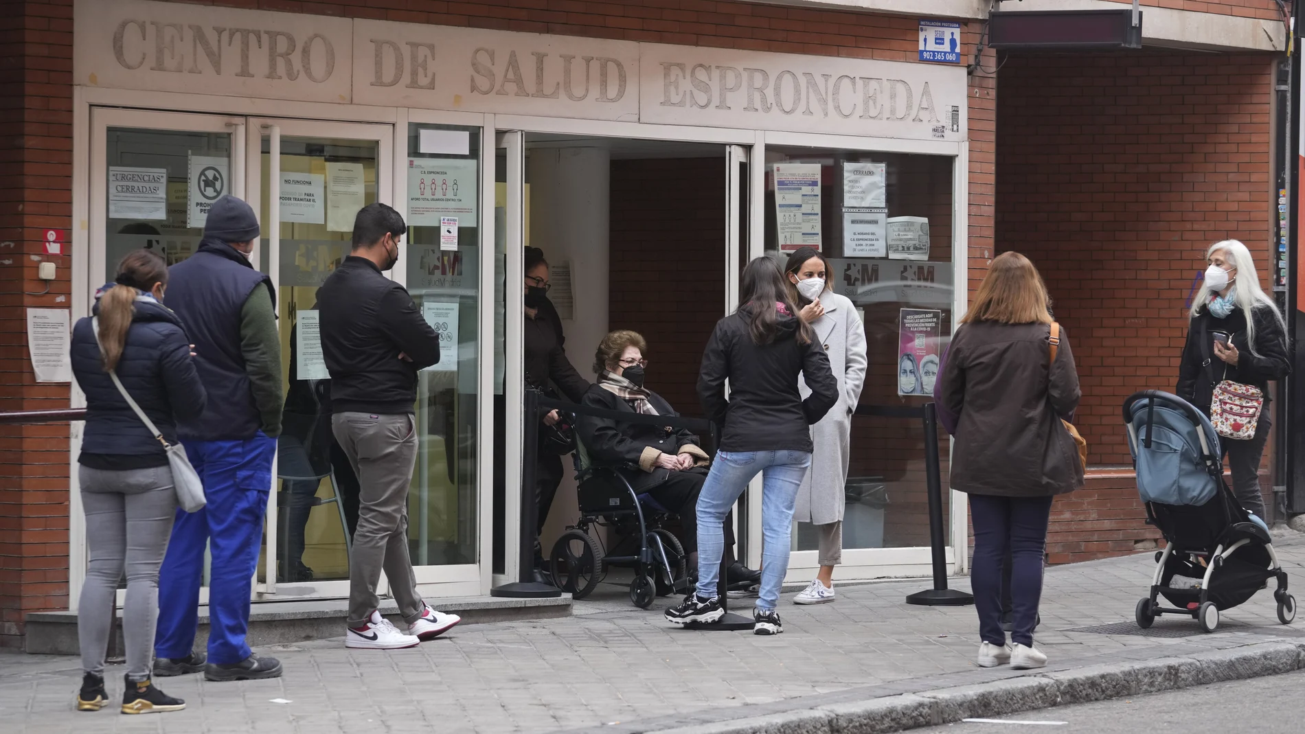 Un grupo de gente hace cola en la puerta de un centro de Atención Primaria en Madrid