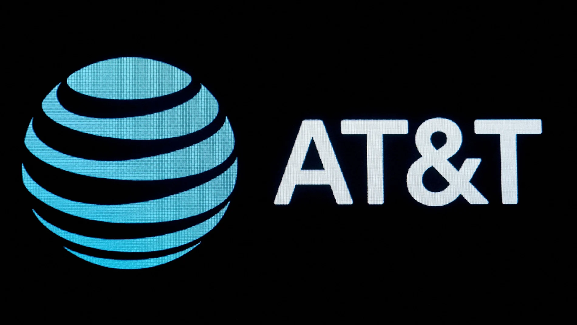 FILE PHOTO: The company logo for AT&T is displayed on a screen on the floor at the New York Stock Exchange (NYSE) in New York, U.S., September 18, 2019. REUTERS/Brendan McDermid/File Photo