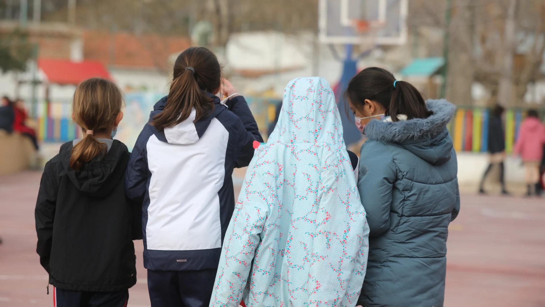 Varias niñas juegan en el recreo de un colegio de Madrid el primer día de clase presencial tras la Navidad
