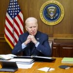 This image provided by The White House via Twitter shows President Joe Biden at Camp David, Md., Saturday, Feb. 12, 2022. Biden on Saturday again called on President Vladimir Putin to pull back more than 100,000 Russian troops massed near Ukraineâ€™s borders and warned that the U.S. and its allies would â€œrespond decisively and impose swift and severe costsâ€ if Russia invades, according to the White House. (The White House via AP)