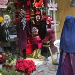 Una mujer afgana pasa junto a una floristería decorado por el Día de San Valentín en Kabul