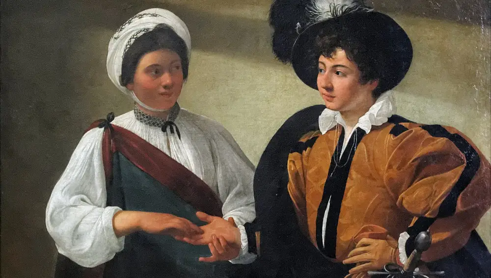 La buenaventura, de Caravaggio (1594-1495, Louvre). Ilustra una lectura de manos | Dominio público