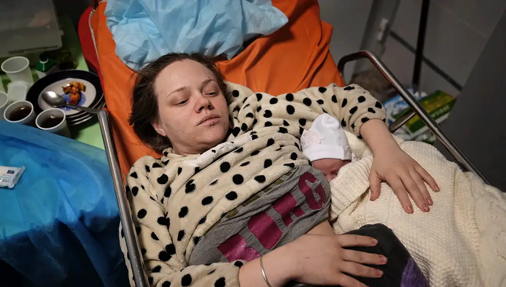 Mariana Vishegirskaya lies in a hospital bed after giving birth to her daughter Veronika, in Mariupol, Ukraine, Friday, March 11, 2022. Vishegirskaya survived the Russian airstrike on a children's and maternity hospital in Mariupol last Wednesday. (AP Photo/Evgeniy Maloletka)