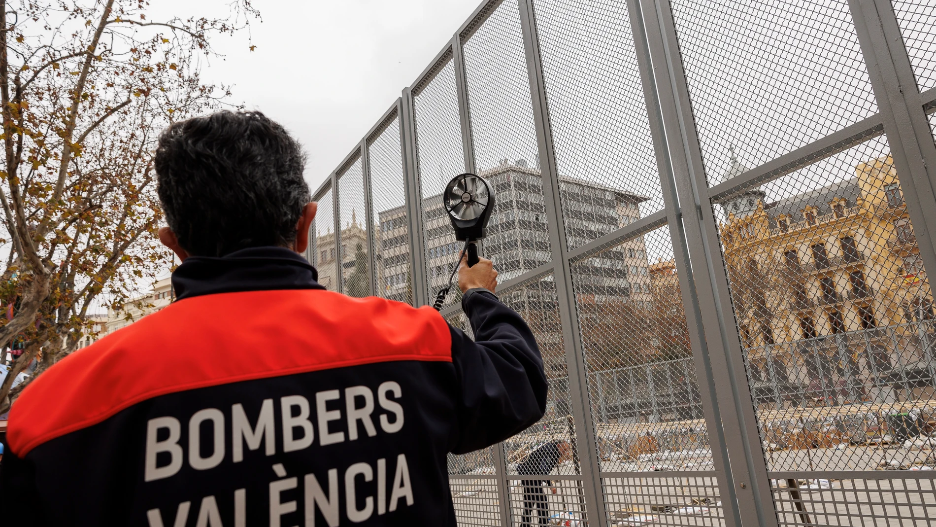 El inspector de bomberos de València, Tomas Asensio, mide la velocidad del viento con un anemómetro para valorar la posibilidad de disparar la mascletà de hoy martes.