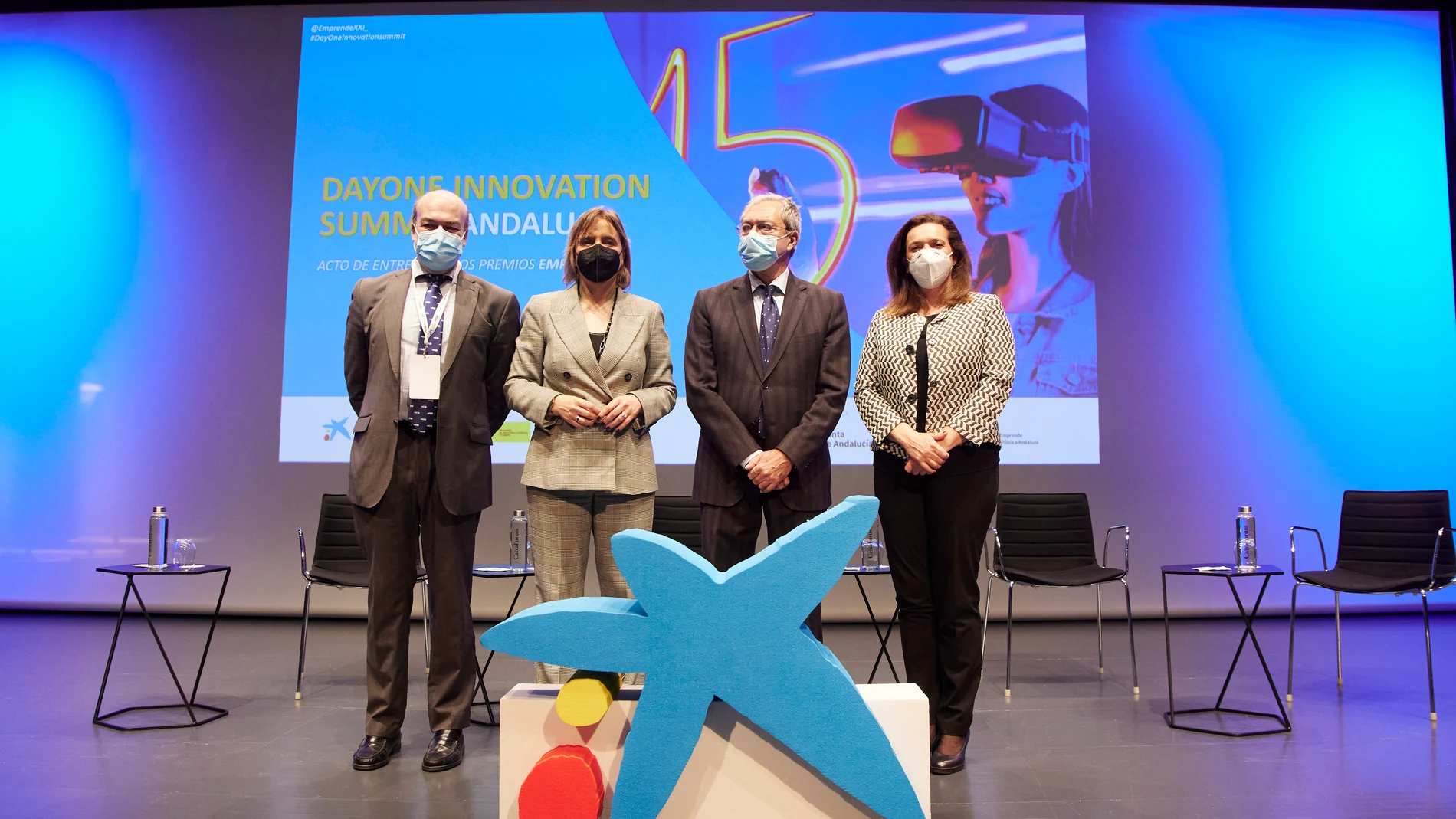 El consejero de Economía, Rogelio Velasco, (2d) junto a la Delegada Terrirorial de Caixa, María Jesús Catalá, (2i) durante los Premios EmprendeXXI en CaixaForum, a 15 de marzo de 2022 en Sevilla (Andalucía, España)