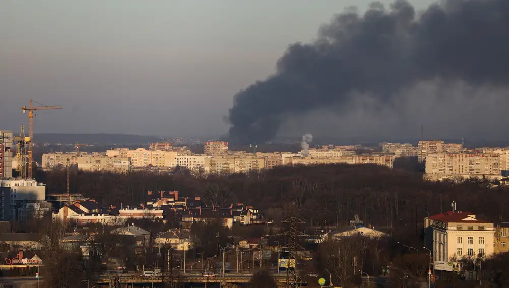 Smoke rises above buildings near Lviv airport, as Russia's invasion of Ukraine continues, in Lviv, Ukraine, March 18, 2022. REUTERS/Roman Baluk