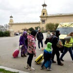Varios refugiados y una traductora, junto a una ambulancia, en la entrada del palacio de Victoria Eugenia, el palacio 7 de Fira de Barcelona, convertido en un centro de recepción y atención de refugiados de Ucrania, a 18 de marzo de 2022, en Barcelona.