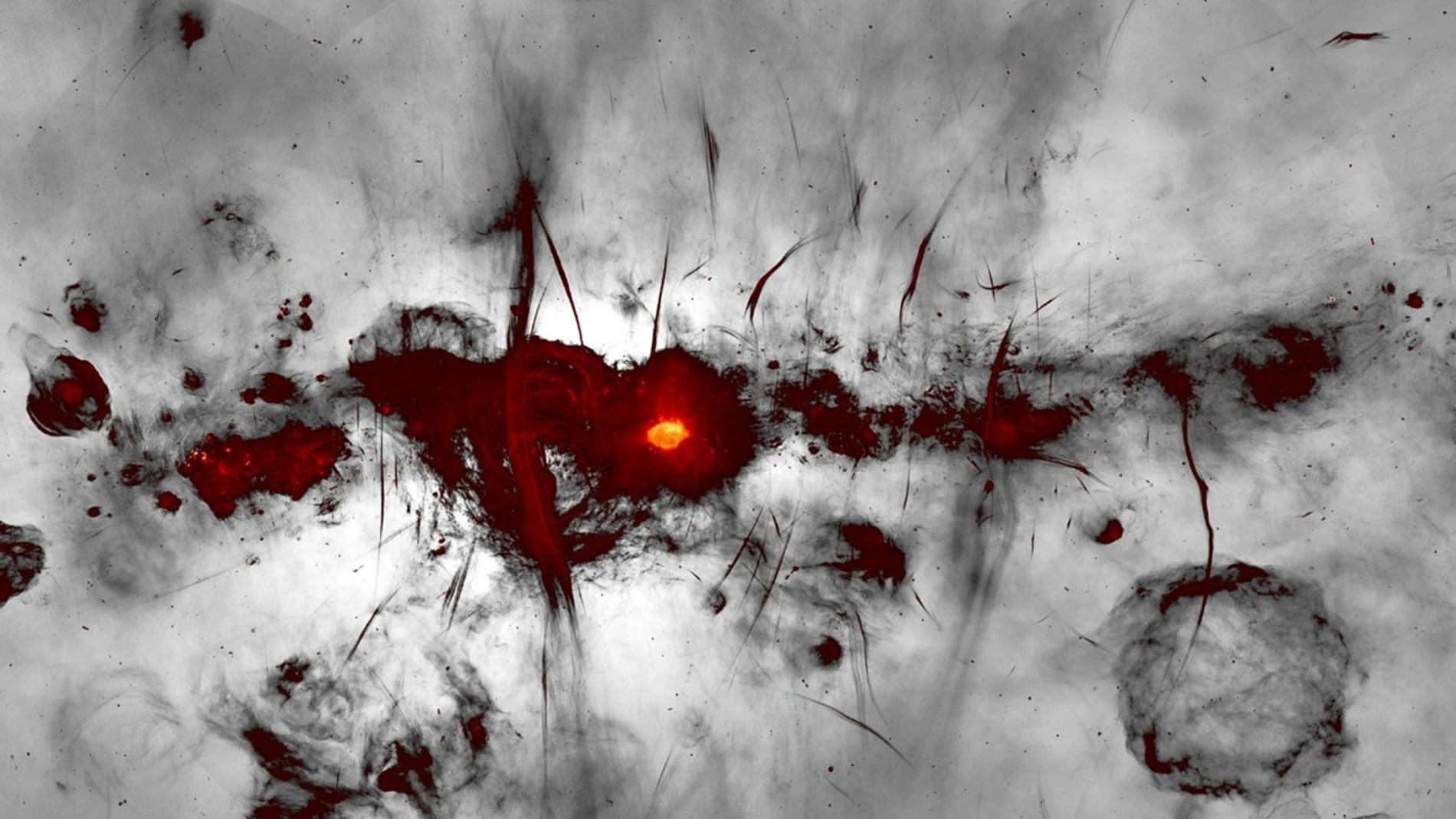 La nueva imagen del MeerKAT de la región del centro galáctico. Los colores indican la emisión de radio brillante, mientras que la emisión más débil se muestra en escala de grises.