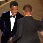 Will Smith (R) hits Chris Rock as Rock spoke on stage during the 94th Academy Awards in Hollywood, Los Angeles, California, U.S., March 27, 2022. REUTERS/Brian Snyder