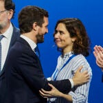 Pablo Casado e Isabel Diaz Ayuso se saludan ayer en Sevilla en presencia del ex presidente del Gobierno Mariano Rajoy