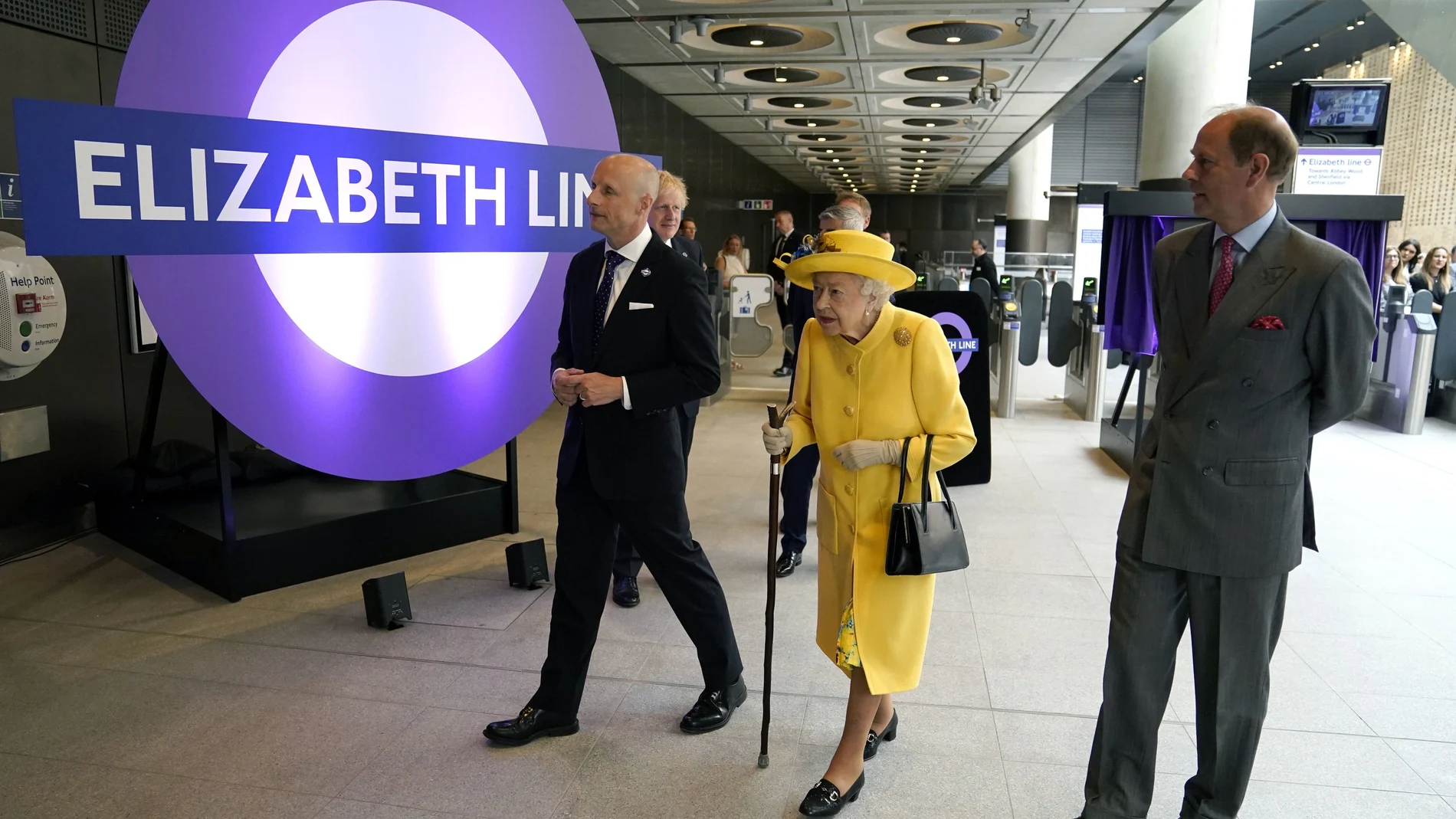 Britain's Queen Elizabeth II and Prince Edward, right, talks with Transport for London commissioner Andy Byford, left, at Paddington station in London meets staff of the Crossrail project, as well as Elizabeth Line staff who will be running the railway, to mark the completion of London's Crossrail project, Tuesday, May 17, 2022. (Andrew Matthews/Pool via AP)