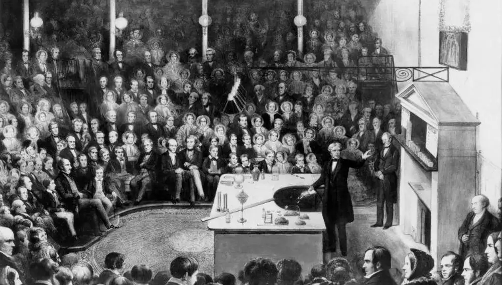 Michael Faraday dando una conferencia de Navidad en la Royal Institution el 27 de diciembre de 1855, a partir de un cuadro de Alexander Blaikley, que conmemora la asistencia de S.A.R. el Príncipe de Gales y S.A.R. el Príncipe Alfredo, al Curso de Conferencias Juveniles, 1855-6.