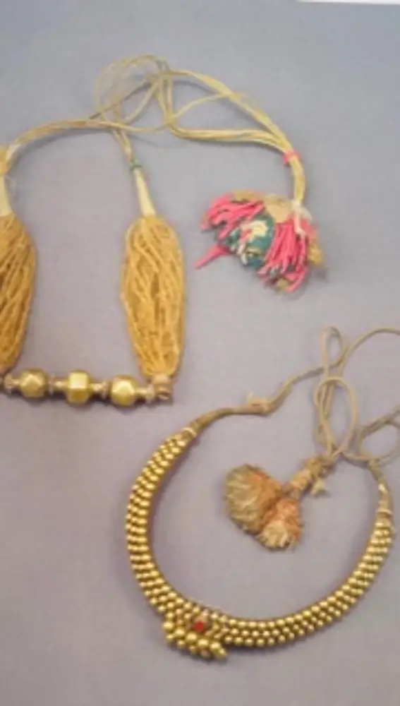 Arriba: India, Rajasthan/Gujarat, primera mitad del S.XX. Collar &quot;Timania&quot; ofrecido a la novia como símbolo de fortuna. Fabricado en oro, cuentas de vidrio llamadas &quot;DE SEMILLA&quot;, seda.Abajo: India. Kelala. Finales del S.XIX. El collar forma parte de la dote Stridhana. Fabricado en oro, núcleo de laca &quot;lac&quot;, rubí, algodón y seda.