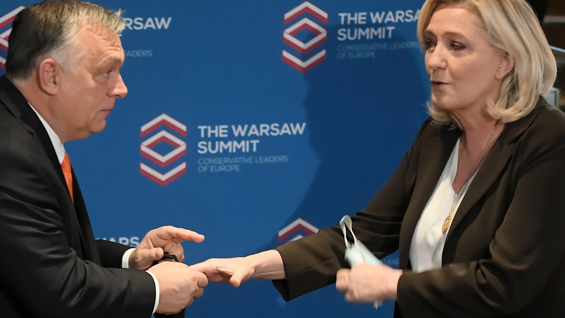 French far-right Rassemblement National party (RN) leader Marine Le Pen (R) and Hungarian Prime Minister Viktor Orban (L) before the Leaders European conservative and right-wing parties meeting 'The Warsaw Summit' at the Regent Hotel in Warsaw, Poland