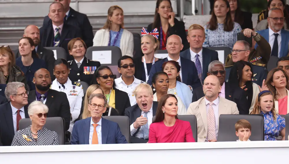 Britain's Prime Minister Boris Johnson, below center, yawns in the royal box during the Platinum Jubilee Pageant outside Buckingham Palace in London, Sunday June 5, 2022, on the last of four days of celebrations to mark the Platinum Jubilee. The pageant will be a carnival procession up The Mall featuring giant puppets and celebrities that will depict key moments from the Queen Elizabeth IIâ€™s seven decades on the throne. (Ian Vogler/Pool Photo via AP)
