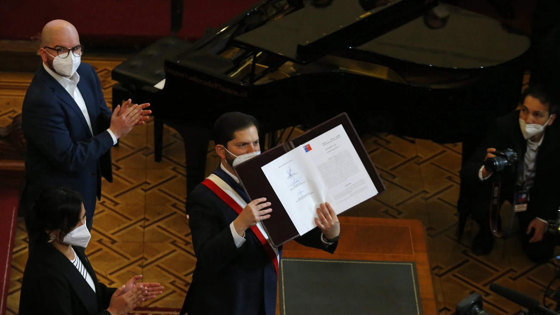 Gabriel Boric sostiene un ejemplar de la nueva Constitución chilena