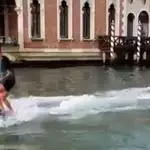 Dos jóvenes haciendo esquí acuático en los canales de Venecia