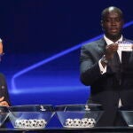 Yayá Touré muestra la papeleta del Real Madrid durante el sorteo de la fase de grupos de la Champions