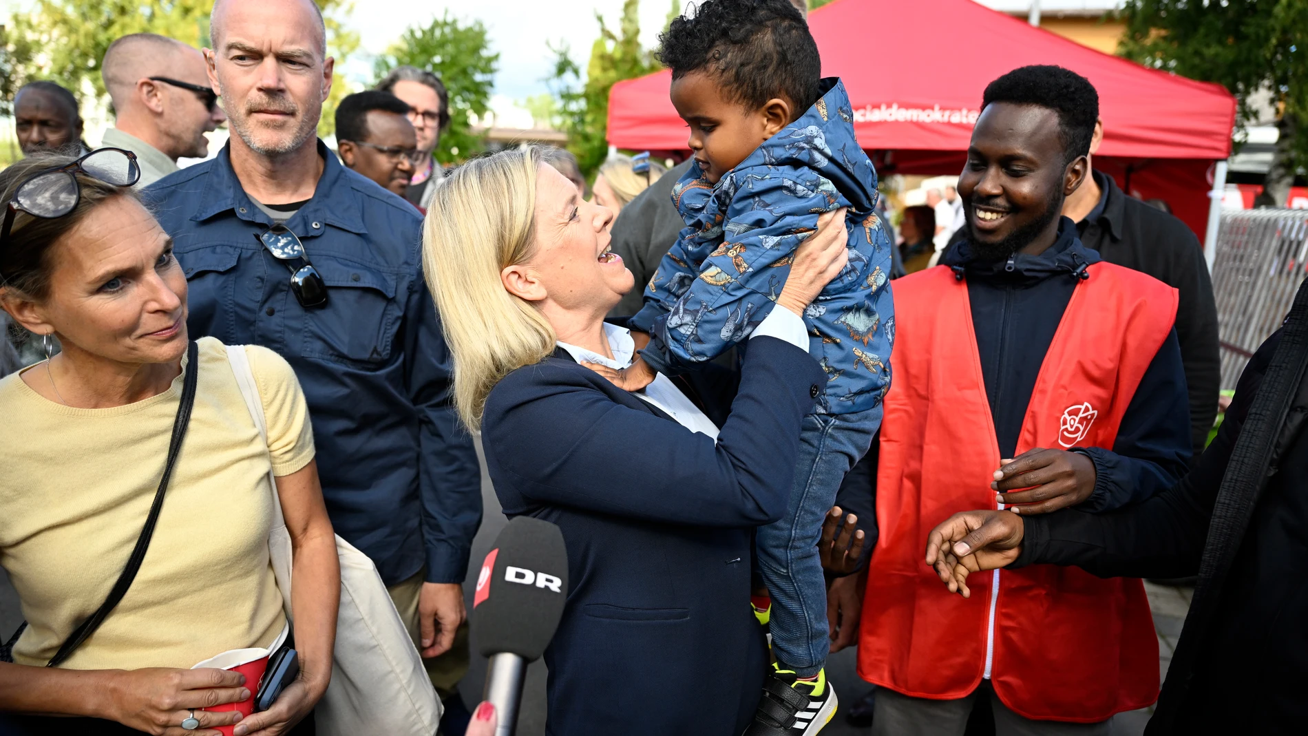 La primera ministra sueca, Magdalena Andersson, sostiene en brazos a un niño en Borlänge