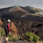 Una turista observa una de las coladas que formaron los ríos de lava durante los 85 días de actividad del volcán, que estalló el 19 de septiembre del año pasado