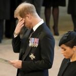 Prince Harry, and his wife Meghan, Duchess of Sussex, pay their respects to Queen Elizabeth II as the coffin rests in Westminster Hall for her Lying-in State, in London, Wednesday, Sept. 14, 2022. (Christopher Furlong/Pool Photo via AP)
