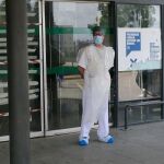 Un sanitario con mascarilla, a la entrada de un hospital